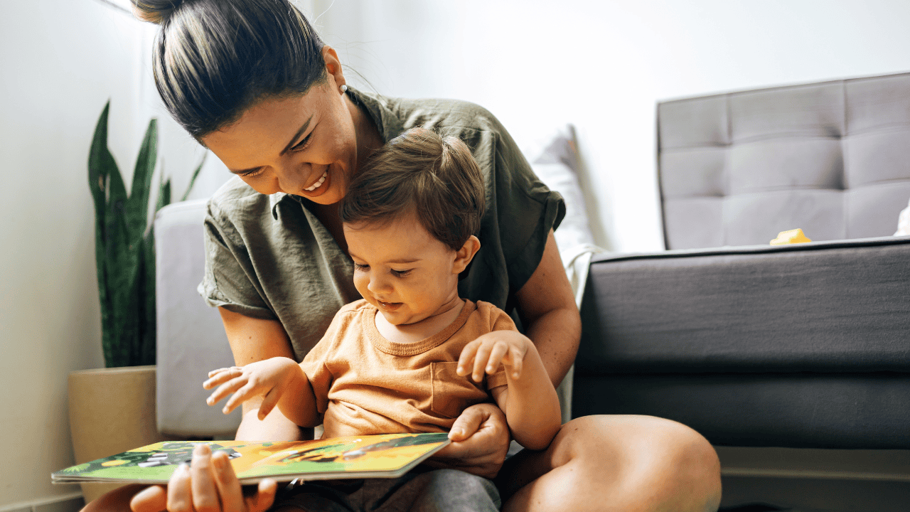 Woman reading to her toddler son.